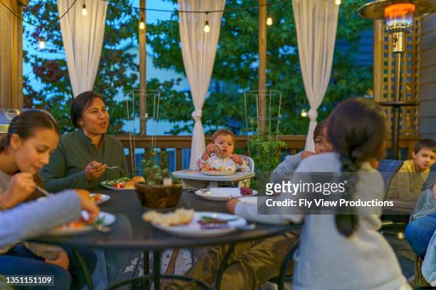 family and friends having dinner party in back yard - chinese eating backyard stock pictures, royalty-free photos & images