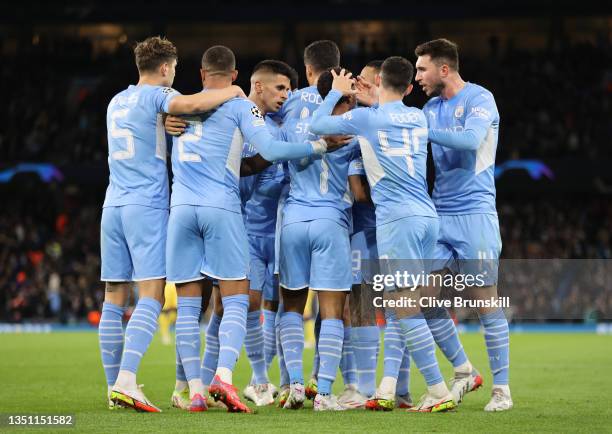 Raheem Sterling of Manchester City celebrates with teammates after scoring their team's third goal during the UEFA Champions League group A match...