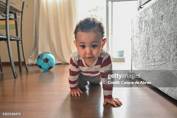 happy baby crawling on the floor - crawling stock pictures, royalty-free photos & images