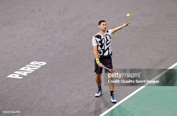 Gianluca Mager of Italy serves during his singles match against Felix Auger-Aliassime of Canada on Day Two of the Rolex Paris Masters at AccorHotels...
