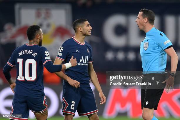 Neymar and Achraf Hakimi of Paris Saint-Germain confront match referee Andreas Ekberg during the UEFA Champions League group A match between RB...