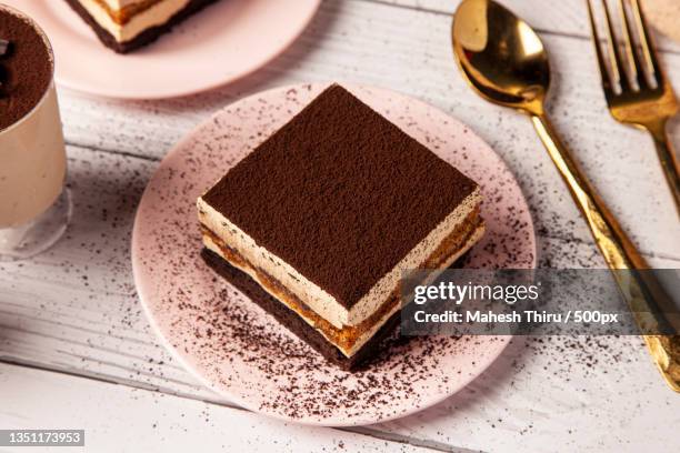 high angle view of cake in plate on table - tiramisu stock pictures, royalty-free photos & images