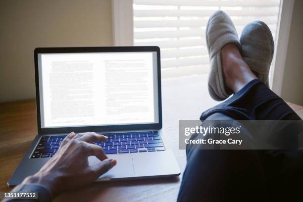 woman works from home with feet up on desk - feet on desk stock pictures, royalty-free photos & images