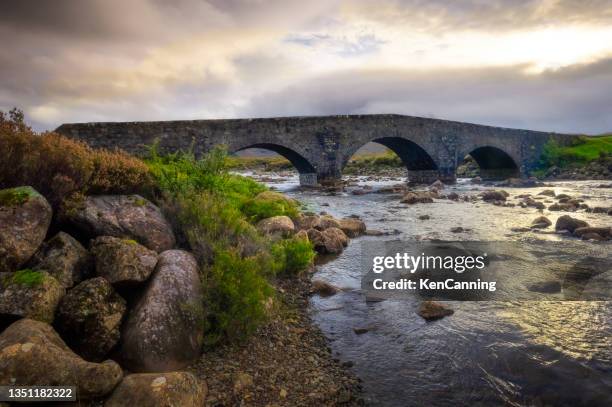 old stone bridge and mountains in mist - western isles stock pictures, royalty-free photos & images