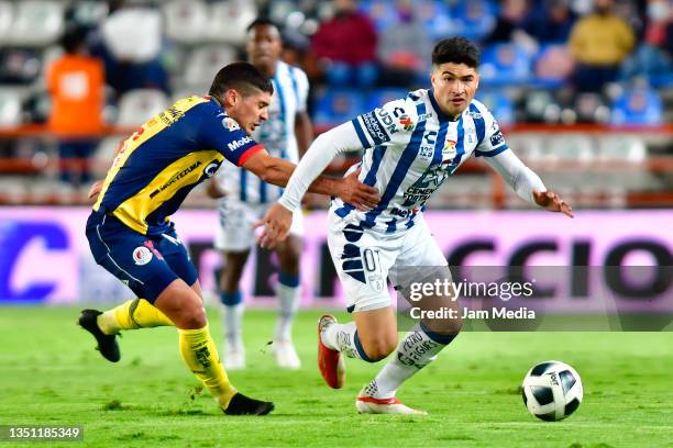 Javier Guemez of San Luis fights for the ball with Nicolas Ibañez of Pachuca during the 5th round match between Pachuca and Atletico San Luis as part...