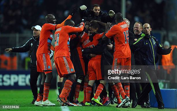 Mathieu Valbuena of Marseille celebrates with team mates after scoring the winning goal during the UEFA Champions League group F match between...