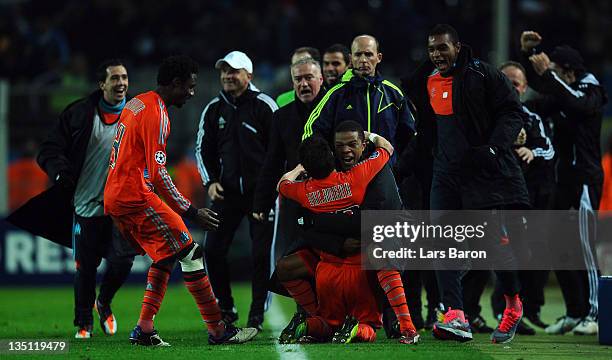 Mathieu Valbuena of Marseille celebrates with head coach Didier Deschamps and team mates after scoring the winning goal during the UEFA Champions...