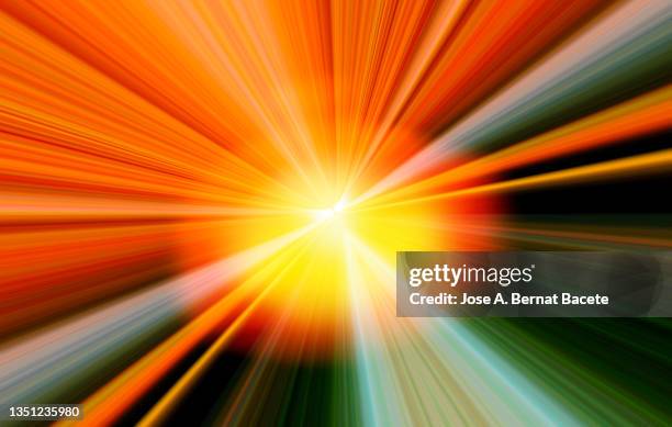 background of explosion of colored light rays with vanishing point. - orange color explosion stock pictures, royalty-free photos & images