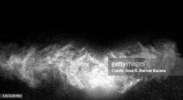 collision of two jets of water droplets under pressure on a black background. - nebel stock-fotos und bilder