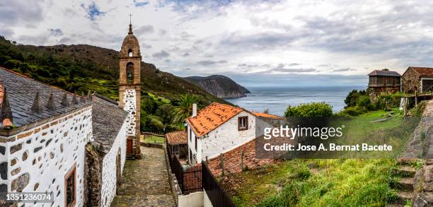 bell tower of the church of a small village by the sea on the coast of galicia - galicia stockfoto's en -beelden