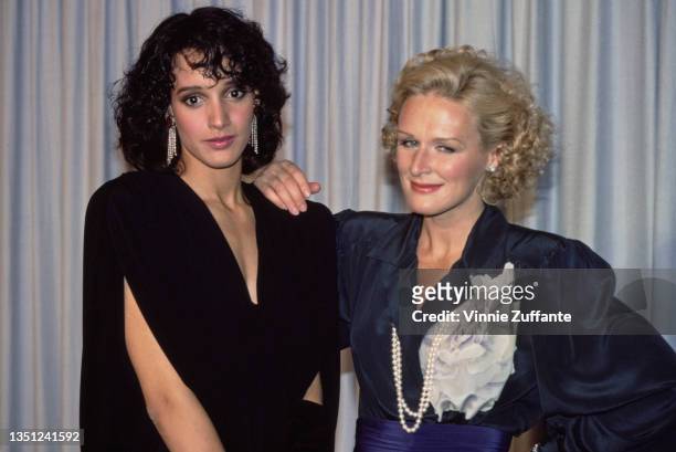 American actress Jennifer Beals and American actress Glenn Close, who has her hand on Beals' shoulder, in the press room of the 57th Academy Awards,...
