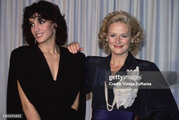 American actress Jennifer Beals and American actress Glenn Close, who has her hand on Beals' shoulder, in the press room of the 57th Academy Awards,...
