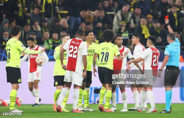 Mats Hummels of Borussia Dortmund is shown a red card by Match Referee, Michael Oliver during the UEFA Champions League group C match between...