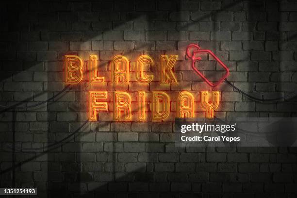 black friday neon text in wall with neon lights style - fridy stock pictures, royalty-free photos & images