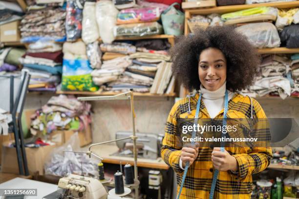 african craftswoman with measure type working in studio - upholstery worker stock pictures, royalty-free photos & images