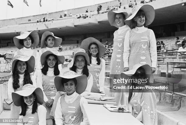 Olympic hostesses posed in their distinctive 1968 Summer Olympics branded dresses and sunhats during a lunch recess inside the Estadio Olimpico...