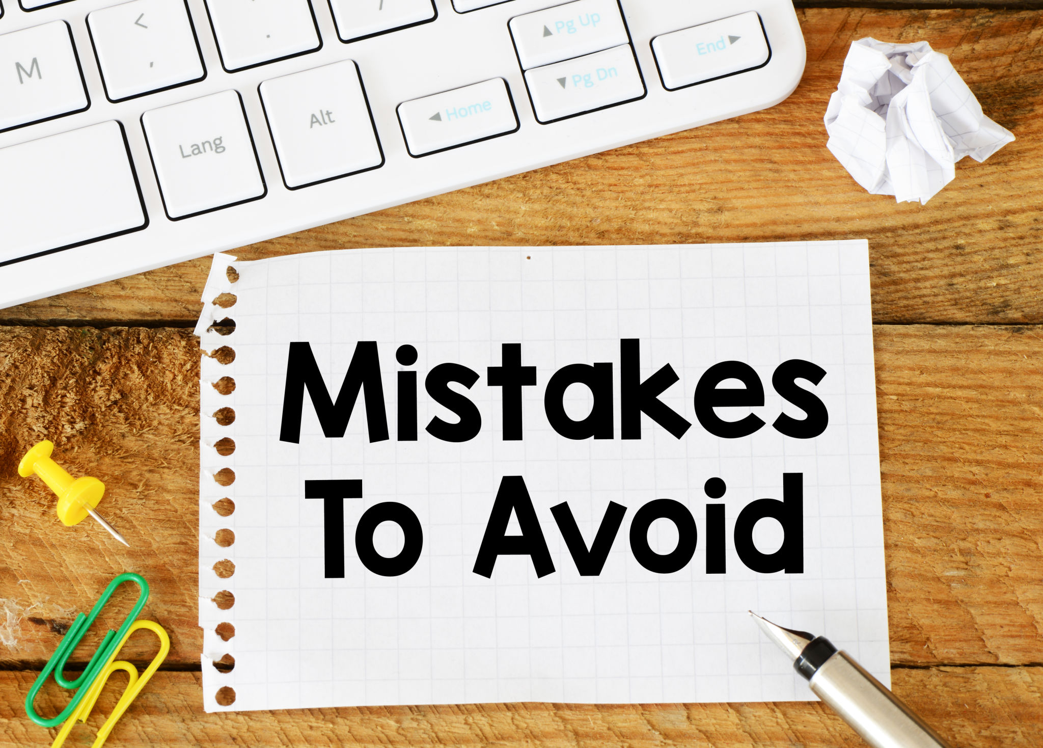 MISTAKES IS AVOID words written in the notebook. MISTAKES IS AVOID words written in the notebook.