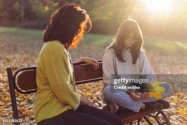 mother and daughter spending time together - autumn sadness stock pictures, royalty-free photos & images