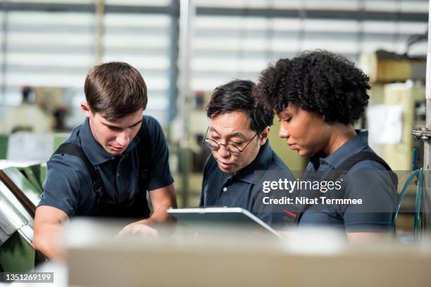 brainstorming in quality assurance. multiracial group of quality control engineers having discussion or decision on engineering parts to ensure that defective products do not go out to the customer based on quality control standards. - public scrutiny stock pictures, royalty-free photos & images