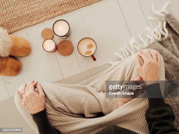 woman indoors meditating drinking coffee and getting some mindfulness time - candle overhead stock pictures, royalty-free photos & images