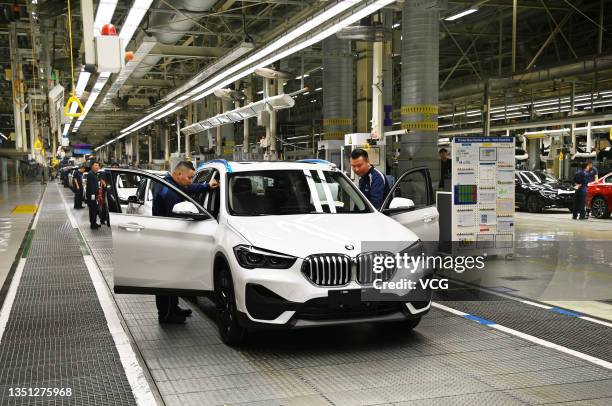 Employees work on the assembly line of X1 compact sport-utility vehicles at Tiexi Plant of BMW Brilliance Automotive on October 23, 2021 in Shenyang,...