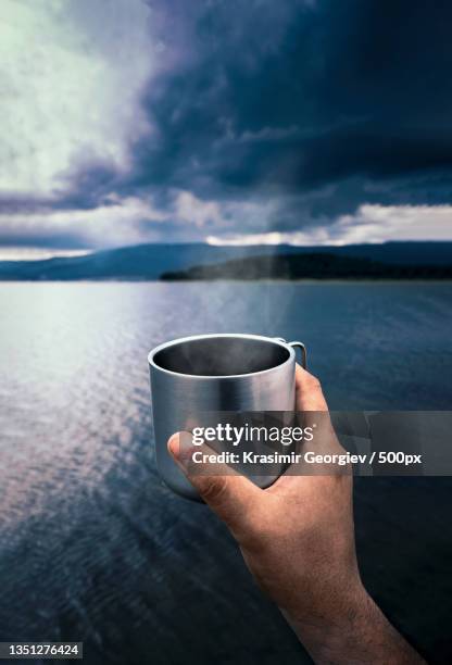 cropped hand holding coffee cup against sea,batak,bulgaria - krasimir georgiev stock pictures, royalty-free photos & images