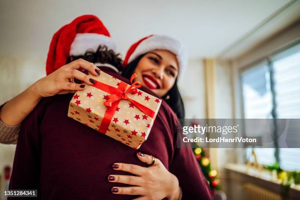 woman receiving a present from her boyfriend - gift exchange stock pictures, royalty-free photos & images