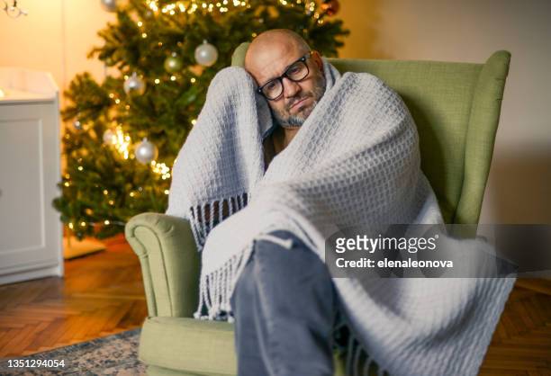 mature adult man in christmas home interior ( in plaid) - tree man syndrome stock pictures, royalty-free photos & images