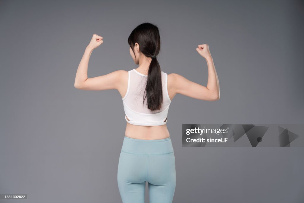 Young And Beautiful Asian Woman Wearing Yoga Pants And Sports Underwear  Practicing Yoga Gray Background High-Res Stock Photo - Getty Images