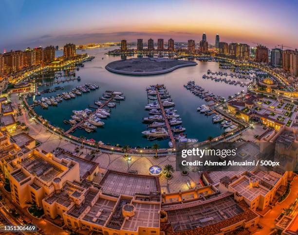 aerial view of illuminated buildings in city at night,doha,qatar - doha buildings stock pictures, royalty-free photos & images