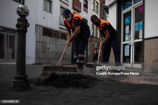 Several Civil Protection personnel remove ash from the streets of the municipality of Los Llanos de Aridane, on November 3 in La Palma, Santa Cruz de...