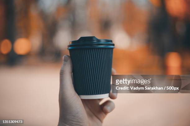 cropped hand holding disposable cup - coffee cup mockup stock pictures, royalty-free photos & images