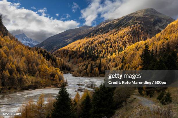 scenic view of lake by mountains against sky,zernez,switzerland - engadin stockfoto's en -beelden