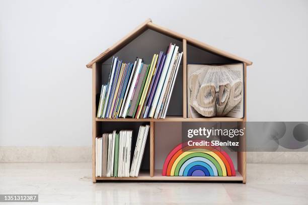 bookshelf loaded with children’s books - tidy bookshelf stock pictures, royalty-free photos & images
