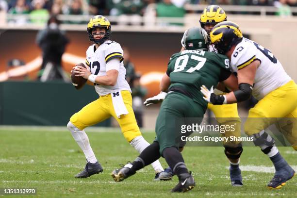 Cade McNamara of the Michigan Wolverines plays against the Michigan State Spartans at Spartan Stadium on October 30, 2021 in East Lansing, Michigan.