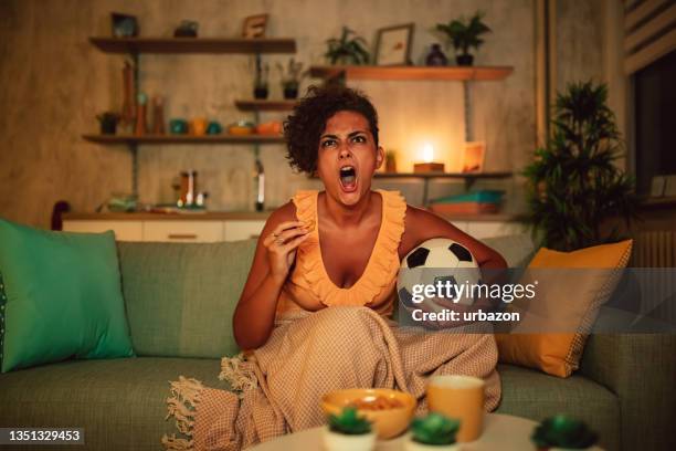 woman with beer watching soccer match on tv - shouting match stock pictures, royalty-free photos & images