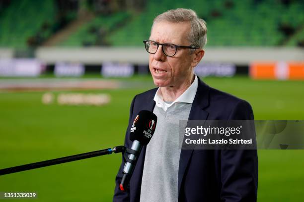 Peter Stoger, Head Coach of Ferencvarosi is interviewed prior to the UEFA Europa League group G match between Ferencvarosi TC and Celtic FC at...