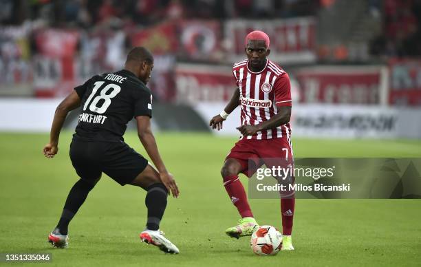 Henry Onyekuru of Olympiakos passes the ball whilst under pressure from Almamy Toure of Eintracht Frankfurt during the UEFA Europa League group D...