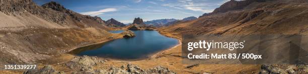 panoramic view of lake and mountains against sky,coni,italy - cuneo stock-fotos und bilder