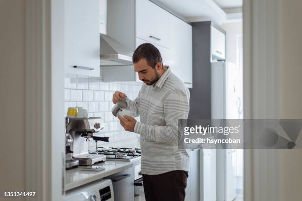 man making coffee at home - espressomachine stockfoto's en -beelden
