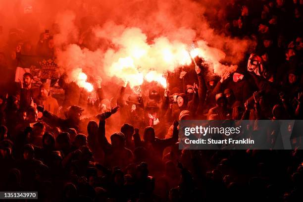 Fans hold flares in the crowd prior to kick off in the UEFA Europa Conference League group E match between 1. FC Union Berlin and Feyenoord at...