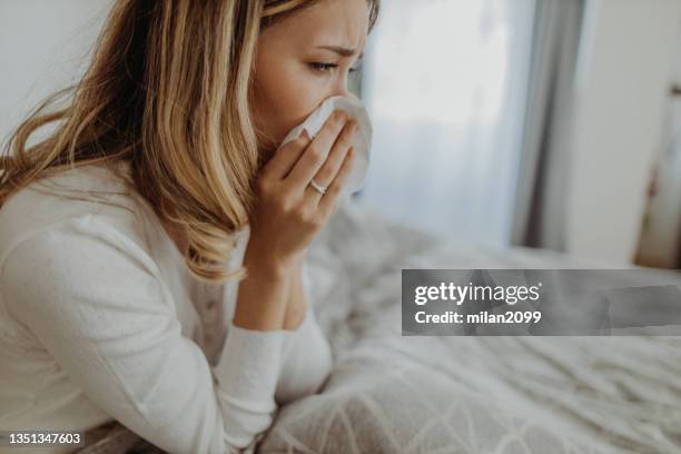 virus - caucasian woman sick in bed coughing stock pictures, royalty-free photos & images