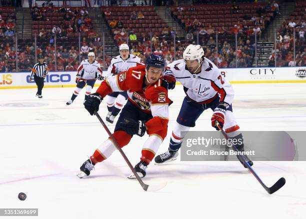 Mason Marchment of the Florida Panthers attempts to get around Justin Schultz of the Washington Capitals during the first period on November 04, 2021...