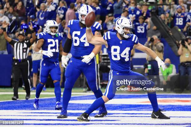 Jack Doyle celebrates scoring a touchdown with Mark Glowinski and Nyheim Hines of the Indianapolis Colts during the first half at Lucas Oil Stadium...