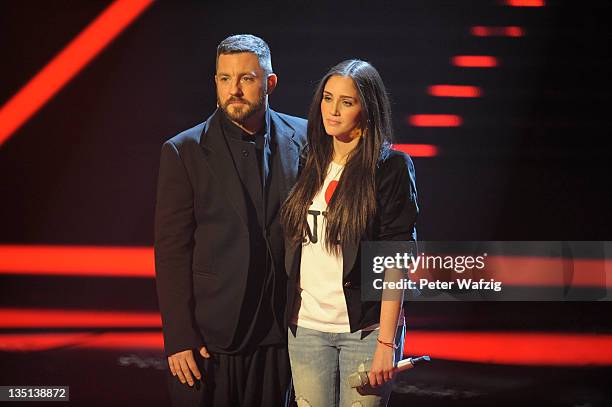 Jury member Mirko Bogojevic and Raffaela Wais are waiting for the results during the 'The X Factor Live' TV-Show Final on December 06, 2011 in...