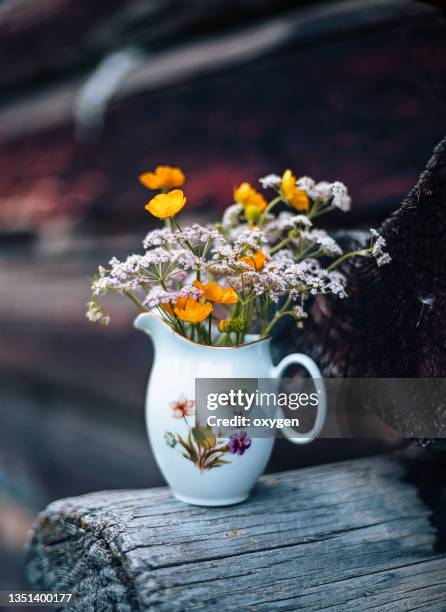 small jag with summer wildflowers outdoor on wooden stump. vintage country retro styled photo. cottagecore aesthetic - herbarium stock pictures, royalty-free photos & images