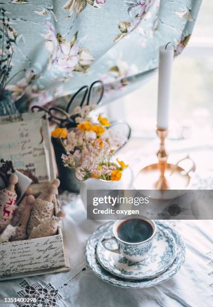 cup of coffee. vintage country retro styled photo. romantic cozy still life scene. sewing items omposition - village home indoor stock-fotos und bilder