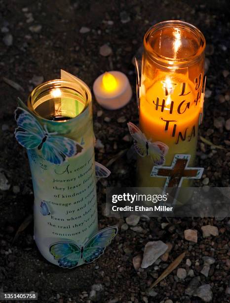Candles are lit at a roadside memorial near the site where Tina Tintor and her dog Max died in a vehicle crash involving former Las Vegas Raiders...