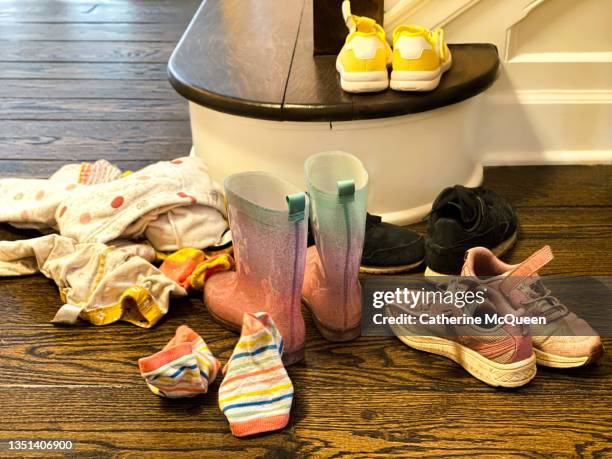 dirty clothes, socks, rain boots & shoes discarded in family’s foyer - muddy shoe print stock pictures, royalty-free photos & images