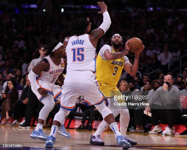 Anthony Davis of the Los Angeles Lakers attempts a shot in front of Derrick Favors and Luguentz Dort of the Oklahoma City Thunder during a 107-104...
